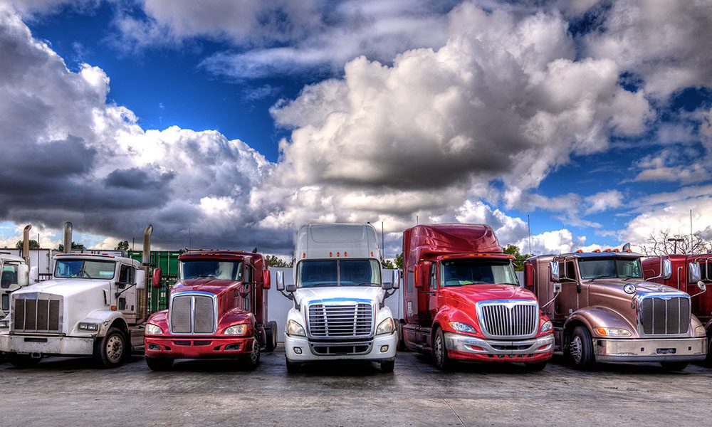 Blog - Trucks Lined Up in a Parking Lot on a Cloudy Day