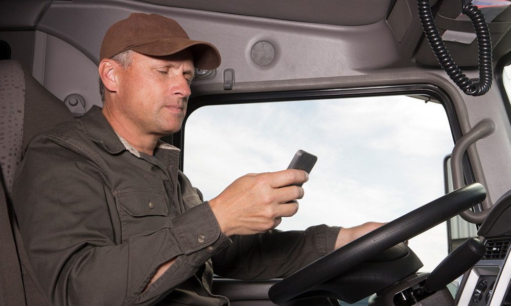 Blog - Commerical Truck Driver Starring at their Phone