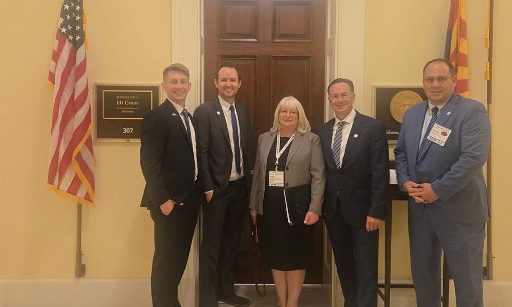 Blog - Strong Tower Team Standing in front of the office of Representative Eli Crane